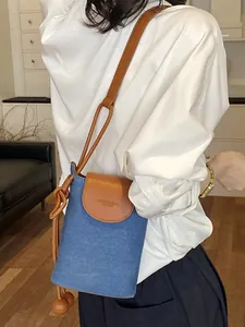 Simple and stylish crossbody phone bag with denim texture and brown leather flap