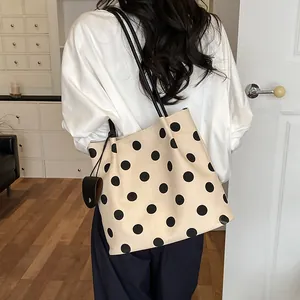 French retro polka dot tote bag styled as a shoulder bag for a chic daily look.