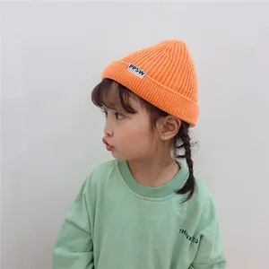 Adorable orange knitted beanie hat for toddlers featuring a stylish rolled edge and PPSW logo tag