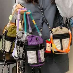 Detailed view of colorful drawstring bucket bags with mesh pockets and woven straps