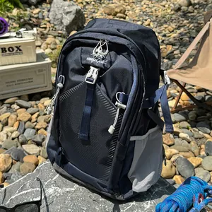 Detailed view of navy blue waterproof hiking backpack in an outdoor camping setting.
