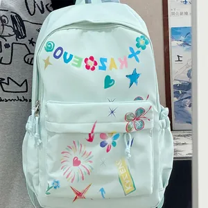 Detailed view of a mint green fashion backpack featuring colorful graffiti stars and heart patterns