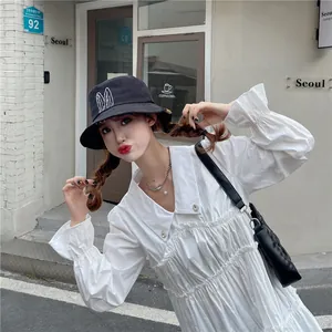 Detailed view of a black bucket hat with cute white bunny ears on an Asian model
