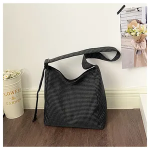 Detail view of casual checkered nylon crossbody bag with adjustable strap for daily use.