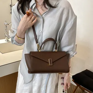 Modern brown leather handbag shown in a lifestyle view on a model for a stylish commute look