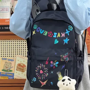 Trendy navy blue nylon backpack with colorful graffiti prints and star plush charm