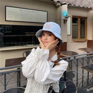 Detailed close-up of a light blue women's bucket hat featuring cute bunny ear embroidery