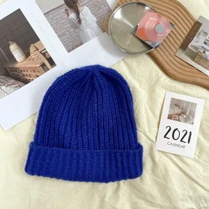 Detail view of vibrant royal blue chunky knit beanie with thick ribbing texture