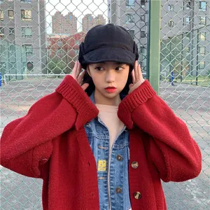 Detail of cute Japanese style black trapper hat with ear protection for women in winter