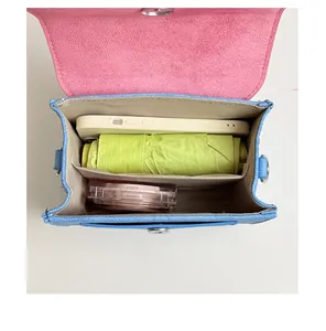 Top view of color-block crossbody bag showing internal storage for phone and umbrella