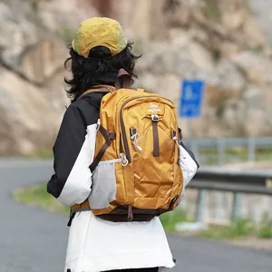 Back view of a woman wearing a lightweight waterproof mustard yellow hiking backpack