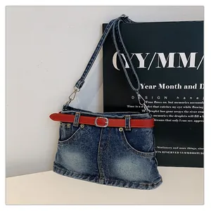 Detailed view of the creative denim skirt shaped crossbody bag with a vibrant red belt