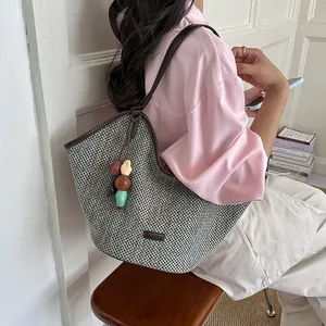 Hand-woven straw tote bag with colorful bead charm, large capacity shoulder travel bag.