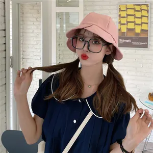 Stylish pink pleated lotus leaf edge bucket hat for women worn by a female model outdoors