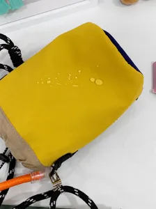 Close-up of yellow water-repellent nylon bucket bag showing waterproof texture