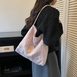 Detail of pink floral embroidery on new Chinese style bucket bag for women