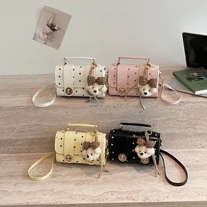 Four vintage polka dot mini crossbody bags in pastel colors featuring a cute bear keychain accessory
