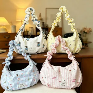 Collection of four stylish dumpling shoulder bags with ruffled handles in various patterns