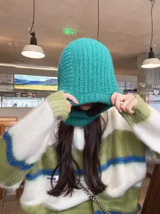 Close-up of teal green knitted balaclava hood showing thick knit texture and hood detail