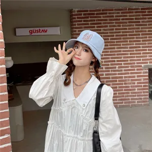 Detail of a light blue bucket hat with cute rabbit ears worn by an Asian model