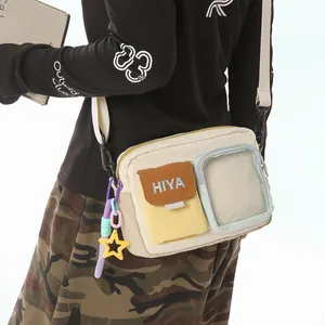 Detailed view of cream casual crossbody bag with decorative star charm and multi pockets