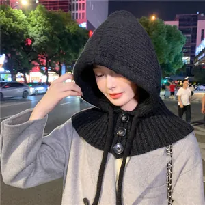 Close-up view of the thick knit texture and button details of a black winter hood