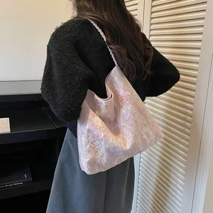 Pink floral embroidery bucket bag shown on a model for a chic New Chinese Style look.