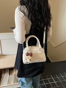 Elegant white pebbled leather Boston handbag with cute puppy charm for daily commute