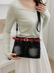 Stylish denim crossbody bag with unique skirt design and a red belt accessory for women
