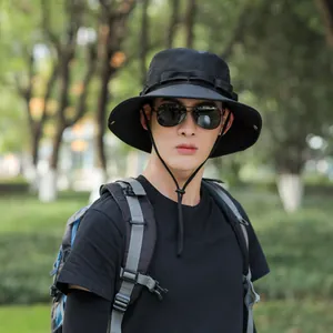 Close-up of a men's black wide-brim bucket hat with adjustable chin strap for outdoors