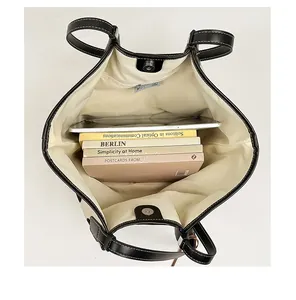 Interior view of the spacious canvas tote bag showing capacity for a tablet and books
