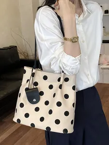 Elegant French retro polka dot shoulder bag in cream and black for chic women's styling.