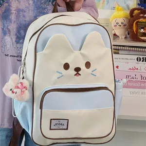 Cute cat-themed backpack in pastel blue and cream with rabbit plush charm detail