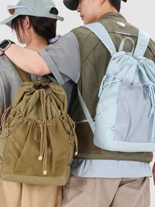 Lightweight grid ripstop drawstring backpacks in olive and light blue for outdoor travel.