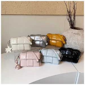 Detailed view of six colorful woven square crossbody bags featuring cute star charms.