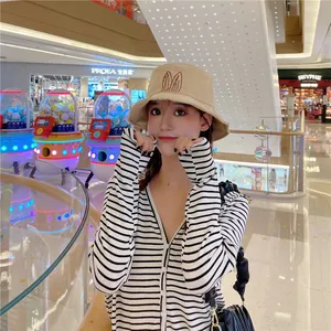 Cute women's bucket hat with rabbit ear embroidery in casual outdoor setting