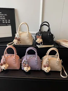 Trendy women's Boston handbags collection in pastel colors with cute plush bear charms
