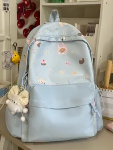 Cute light blue school backpack with cartoon bear patterns and white plush pendant