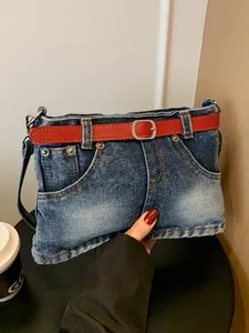 Creative denim crossbody bag featuring a unique jeans design with a red belt accent.