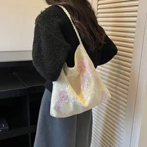 Close-up of a floral embroidered tote bag with braided handle for everyday use