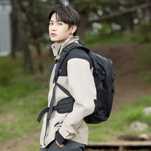 Detailed side view of a professional black outdoor hiking backpack worn by a male model