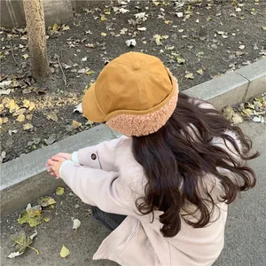 Rear view of a stylish tan winter trapper hat featuring warm faux fur ear flaps for women