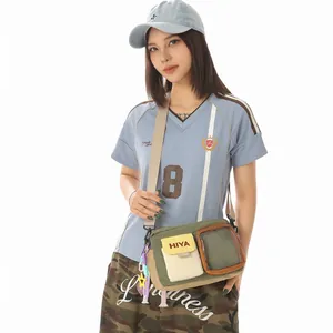 Casual olive green and khaki messenger bag with clear pocket shown on model in studio setting