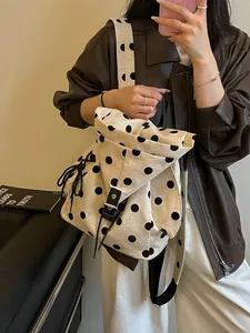 Stylish beige linen backpack with large black polka dots for casual women's fashion