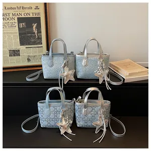 Detail of light blue mini bucket bags with silver star charms and rhinestone accents.