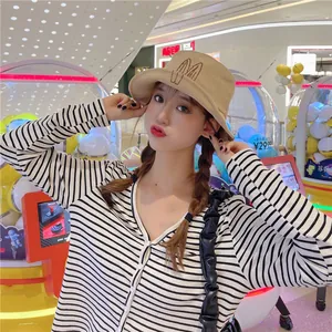 Detail view of a cute beige bucket hat featuring embroidered rabbit ears design.