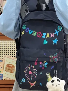 Stylish black backpack with colorful graphic prints and a plush star charm detail