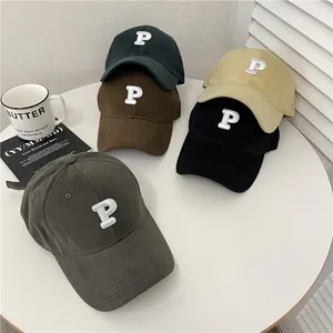 Collection of stylish baseball caps with P letter embroidery displayed on a white table