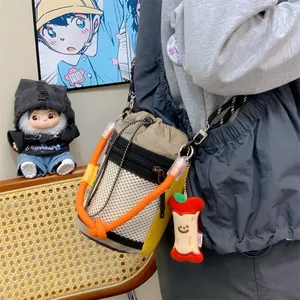 Trendy niche design mesh bucket bag with orange rope handle and cute apple charm detail.