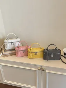 Stylish mini vanity box handbags shown in white, pink, yellow and grey shades